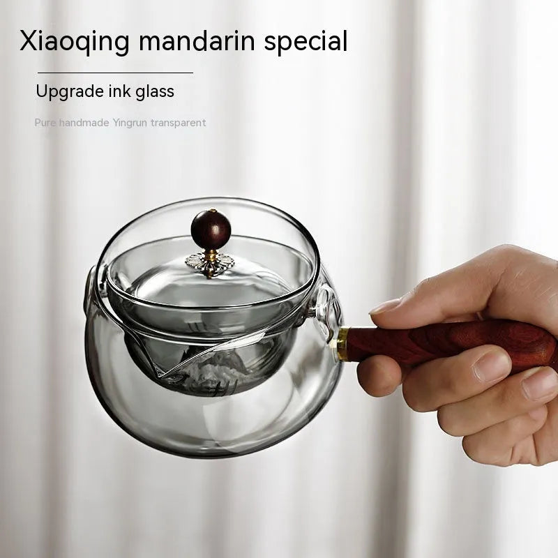 Semi-automatic rotary glass teapot with wooden handle and infuser, in grey and transparent colour options.