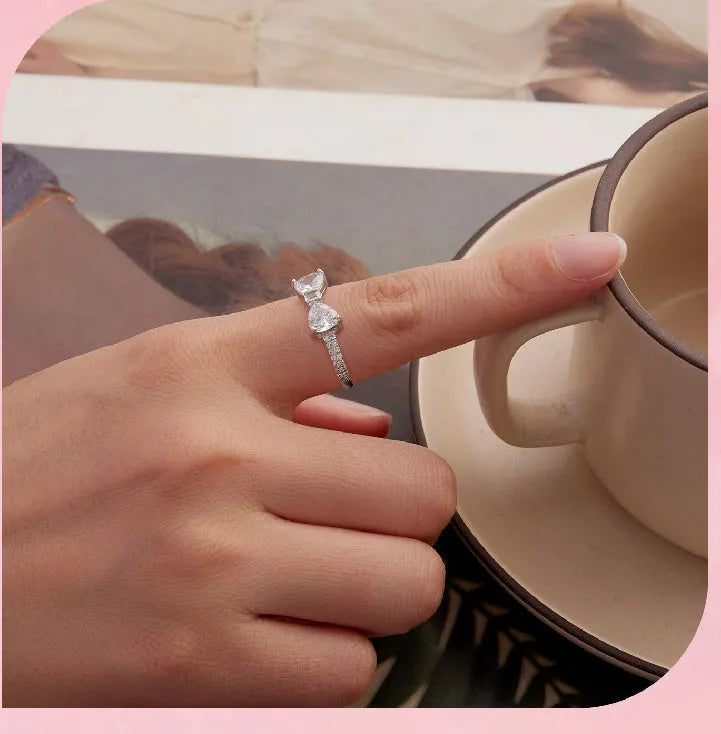 Sterling silver bow ring with zircon stone, available in sizes 6, 7, and 8, electroplated finish