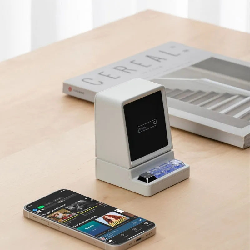 Portable computer-shaped Bluetooth speaker in light grey with lighting and voice prompt function