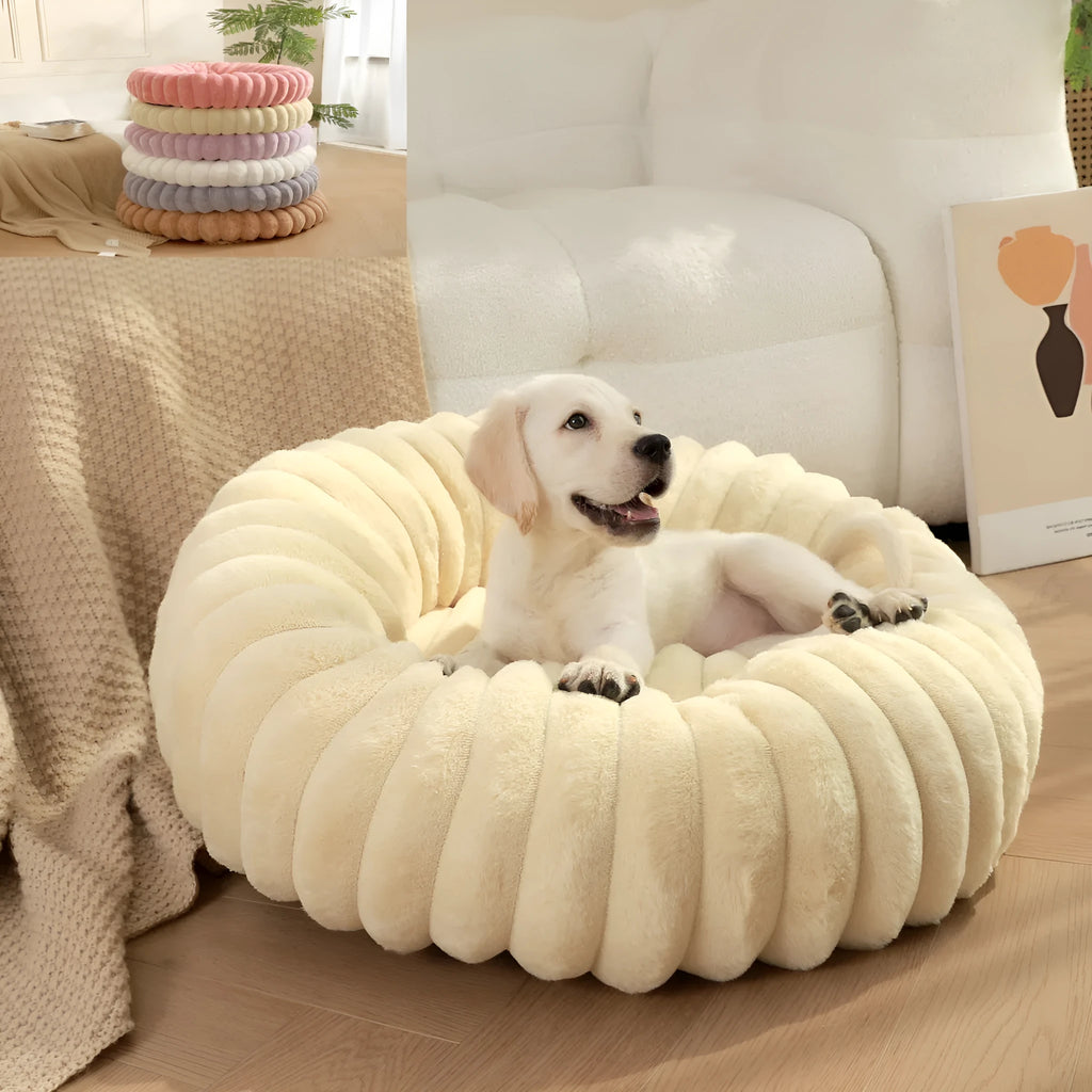 Round plush pet nest mat in beige, shown with a cat curled up inside.