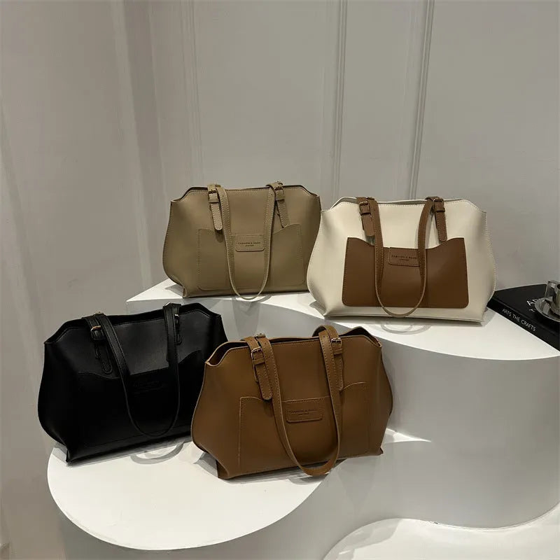 Women's black PU tote bag with shoulder straps showing internal mobile phone pocket