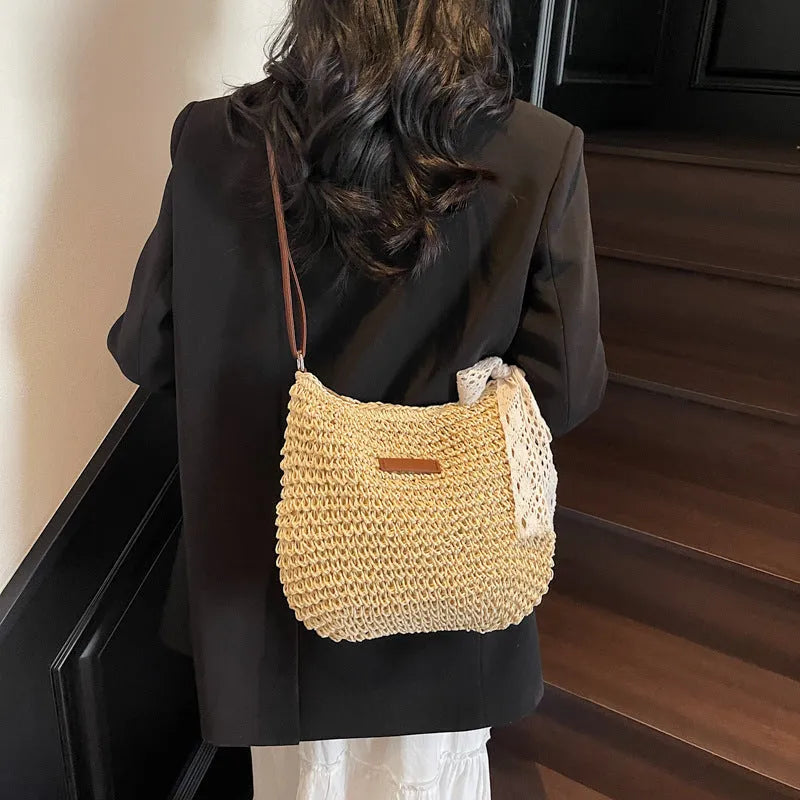 Women's woven straw messenger bag with hollowed design in khaki colour