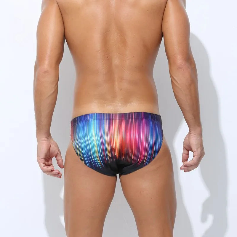 Printed men's swimming trunks in polyester fabric showing colour options Cyber, Ice Cream, Streamer, and Skull.