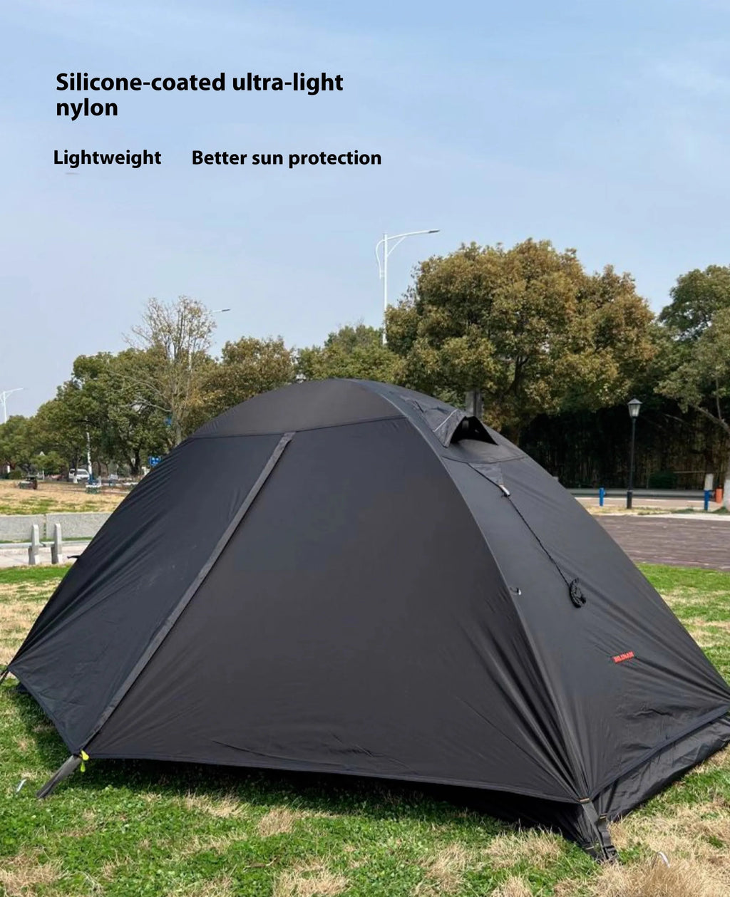 A single person hiking tent with aluminium poles, shown in a black colour option, packed to show its compact size.
