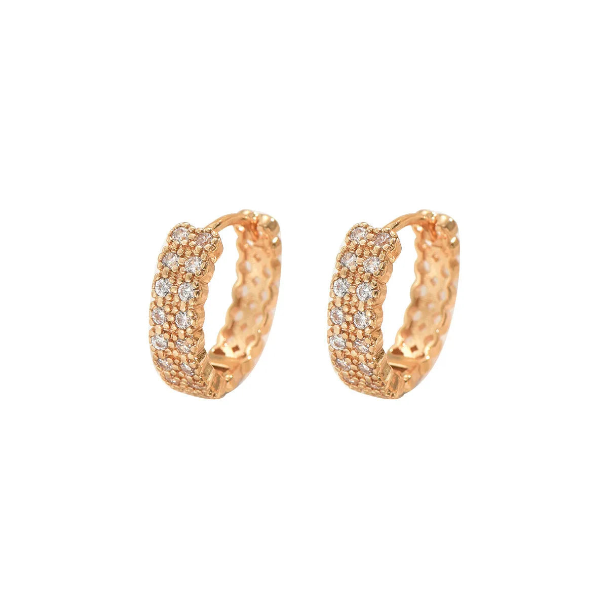 A pair of copper geometric pattern ear studs with round, dot, and ring design elements.