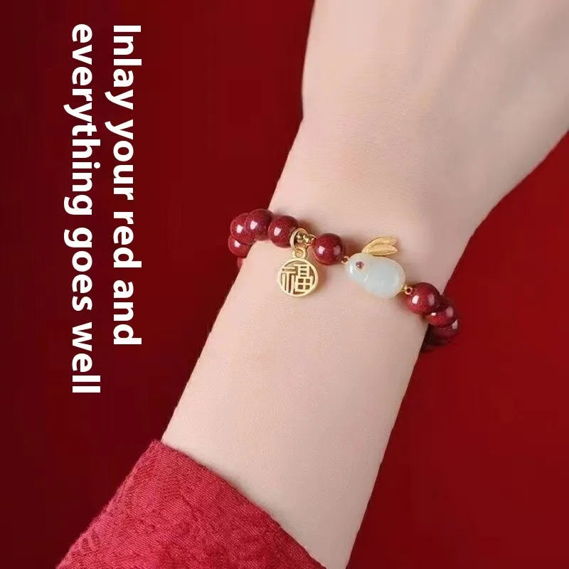 Purple gold sand cinnabar bracelet with a jade hare charm, shown in 6mm and 8mm bead sizes.