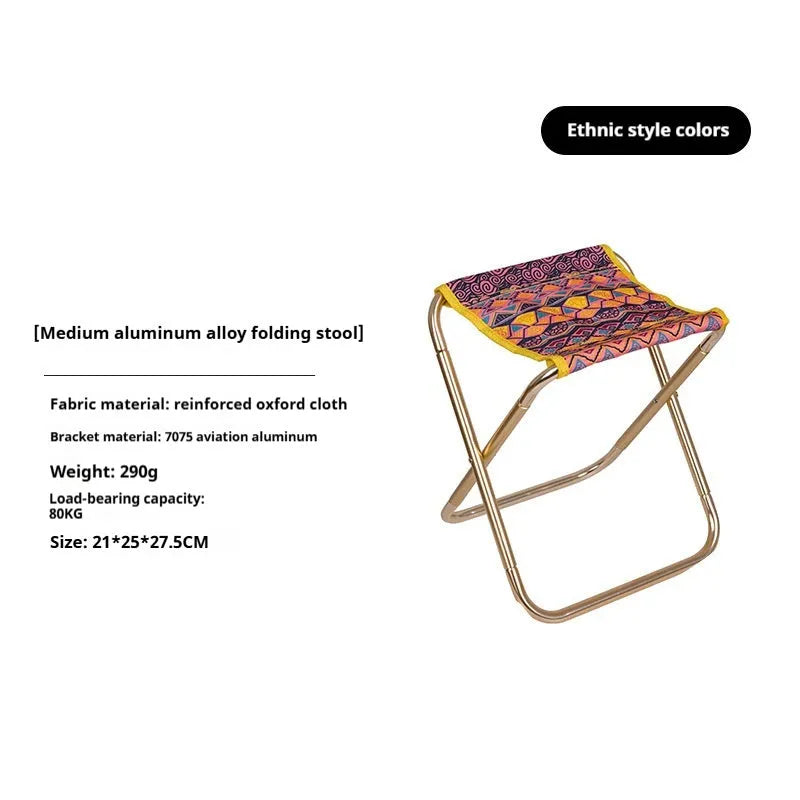 Black ethnic style aluminium alloy folding stool set up on grass.