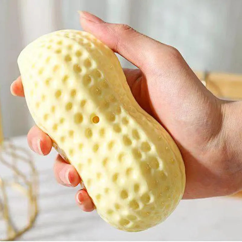 Yellow peanut-shaped dog chew toy with textured surface for teeth cleaning