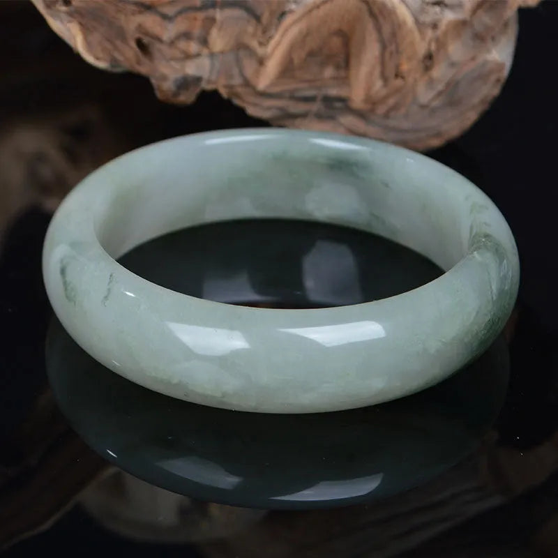 Natural Tianshan Jinsi Jade Chinese style bracelet showing circular form on a plain background.