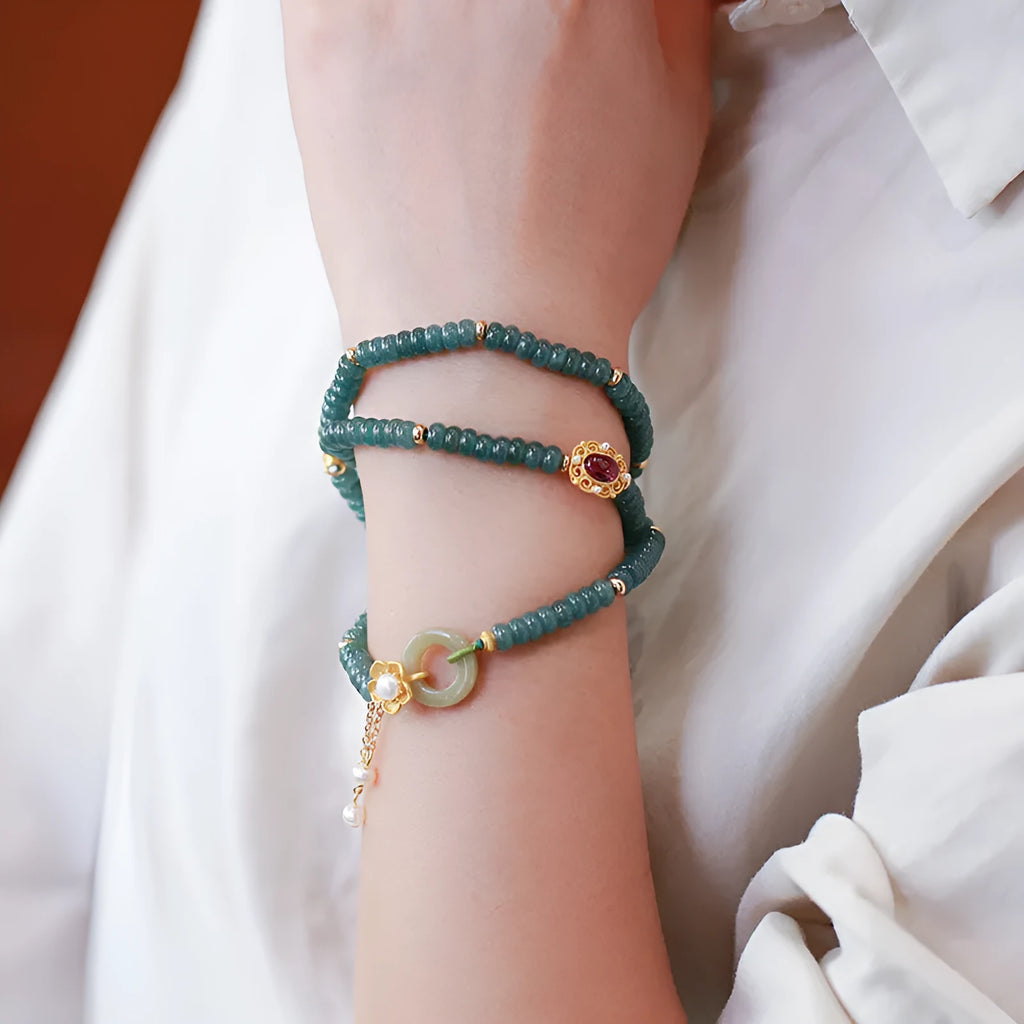 Blue water abacus and jade bead bracelet with tourmaline pearls in a three-ring design.