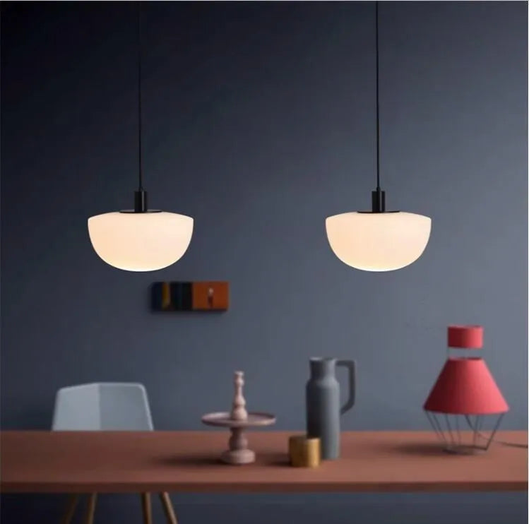 Simple modern milky white glass single-head pendant light suspended from ceiling