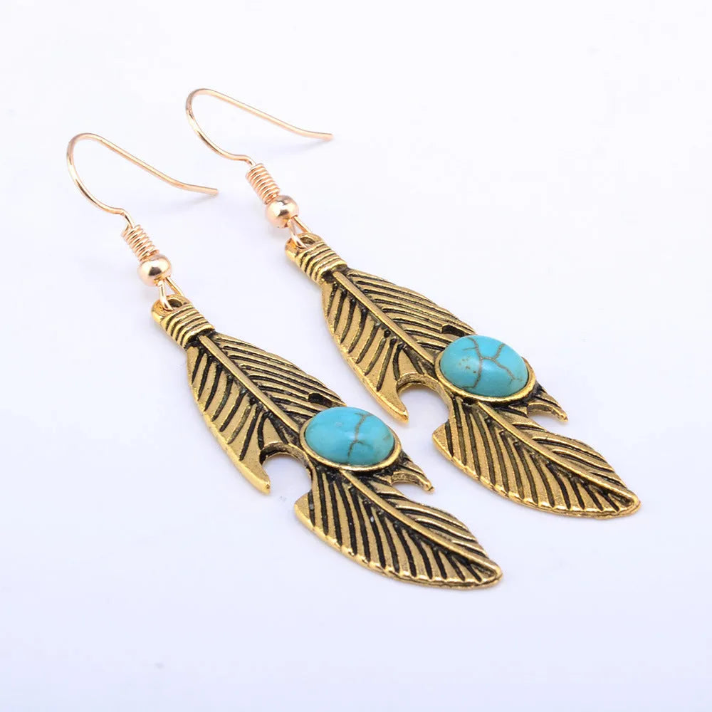 Vintage feather earrings with turquoise inlay leaf pattern in antique gold