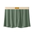 Pack of three men's solid colour loose fit ice silk boxer shorts on a white background