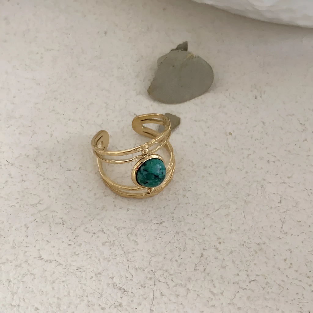 Geometric open ring with a green natural stone set on a titanium steel electroplated band.