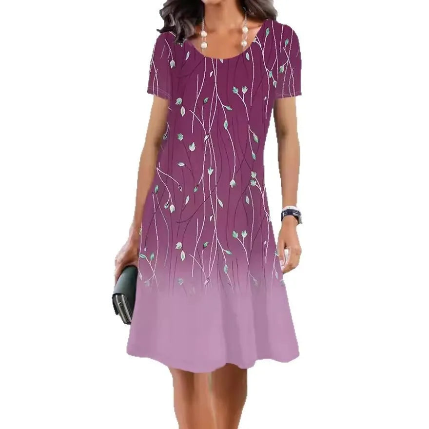 Light blue mid-length dress with white plants and flowers print, A-line skirt, and short sleeves.