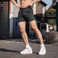 Men's black polyester straight-cut fitness shorts on a size chart