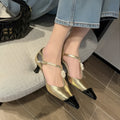 Women's gold stiletto heel with pointed toe, flower buckle, and shallow mouth cut on a sheepskin upper.