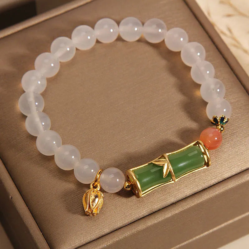 Women's white agate and jade beaded bracelet with bamboo joint connector in retro Chinese style.