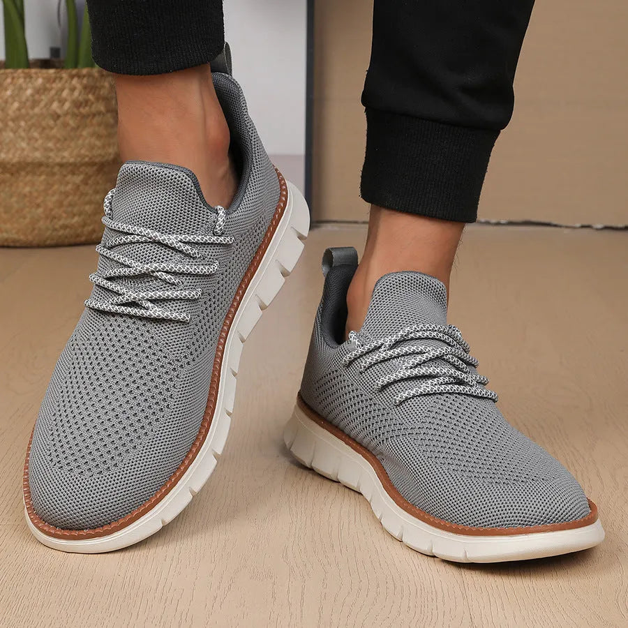 Men's grey mesh casual sneakers with round toe and low-cut design on a white background.