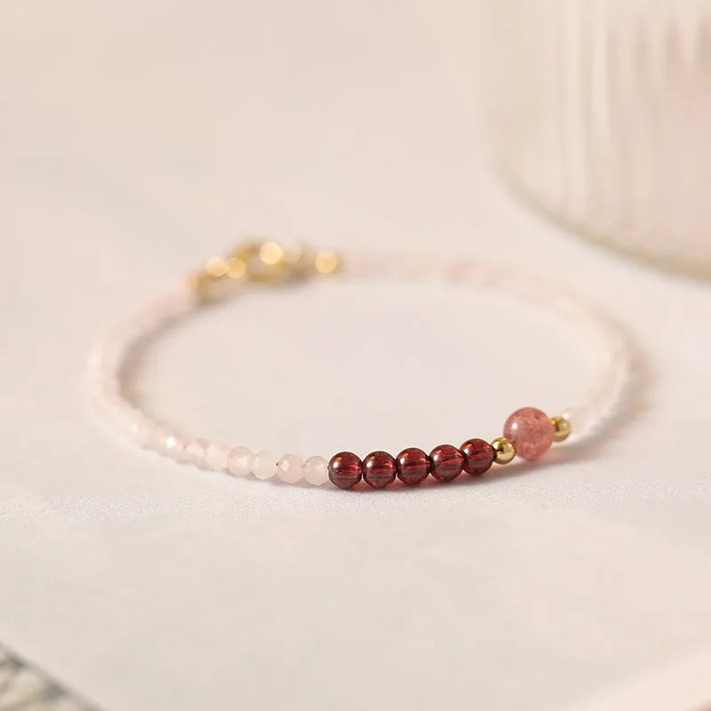 Handmade pink crystal bracelet with strawberry quartz beads and animal zodiac design