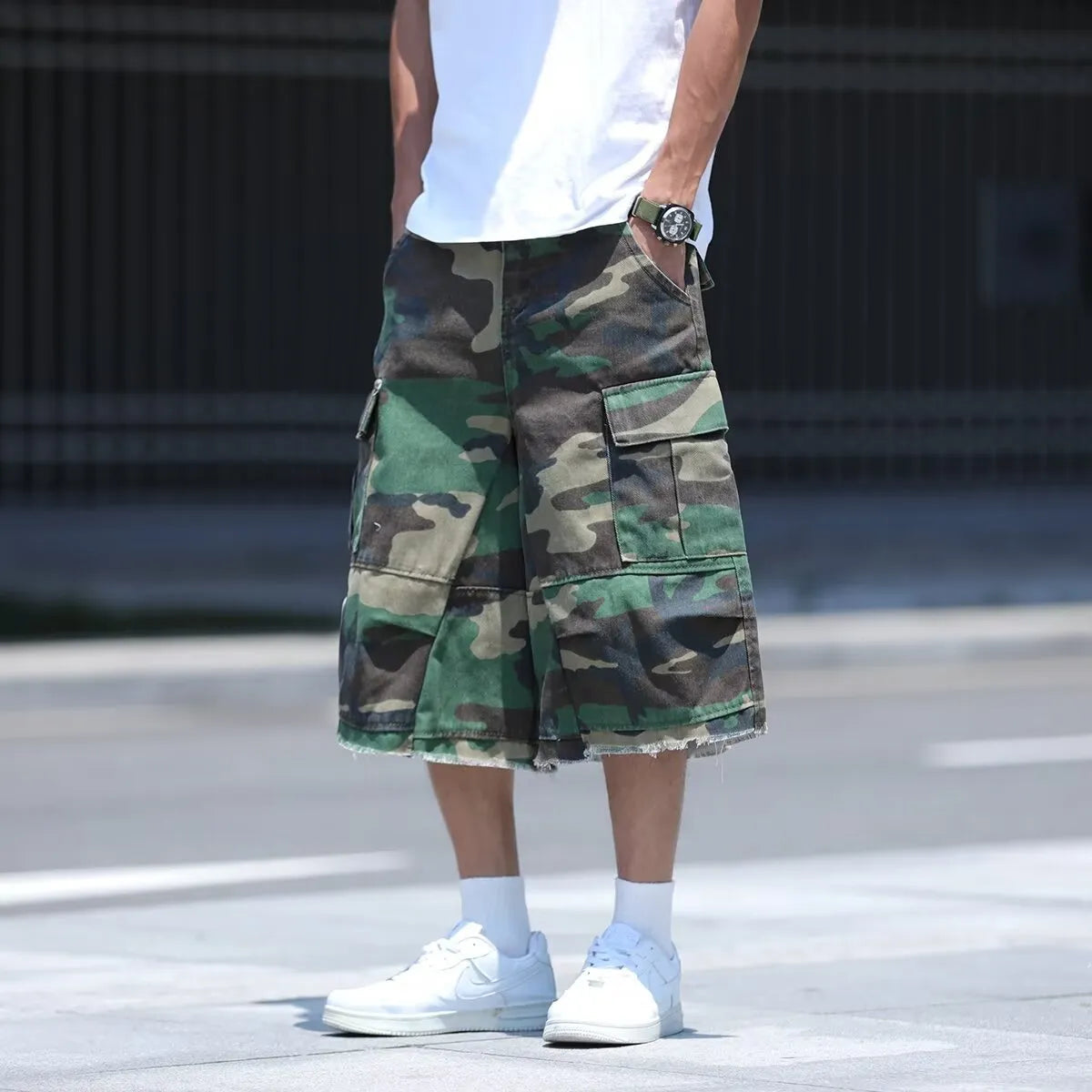 Man wearing loose fit camouflage retro workwear shorts in a khaki camouflage pattern.