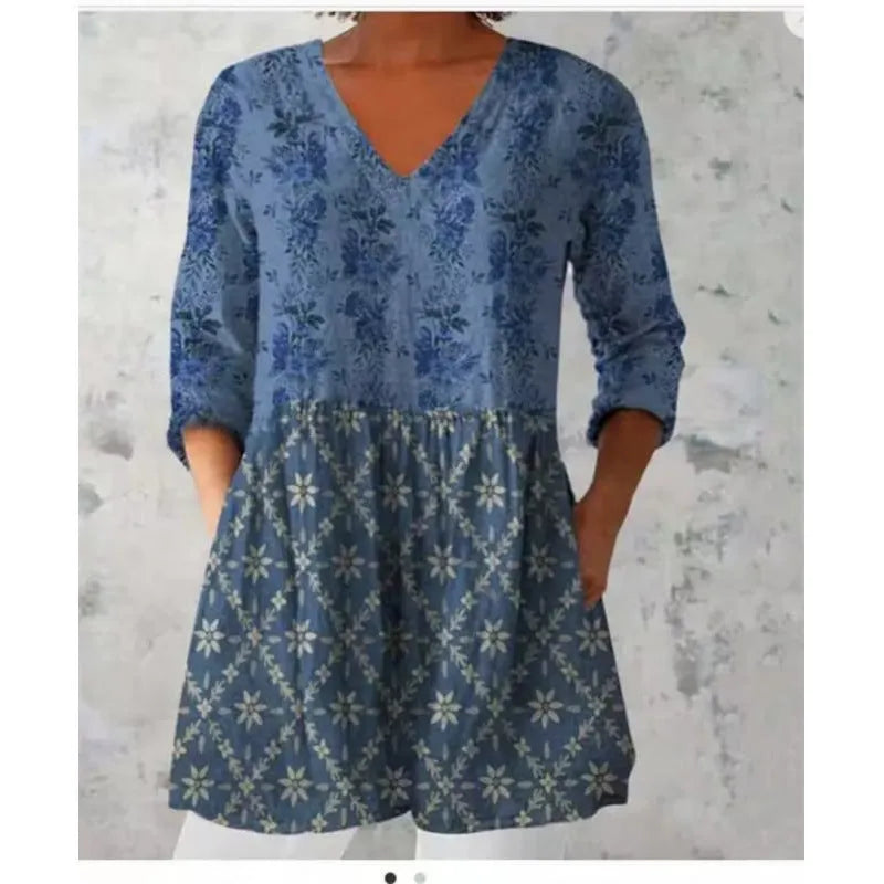 Women's loose-fitting dress with a wave print pattern, wide waist, and three-quarter length sleeves.