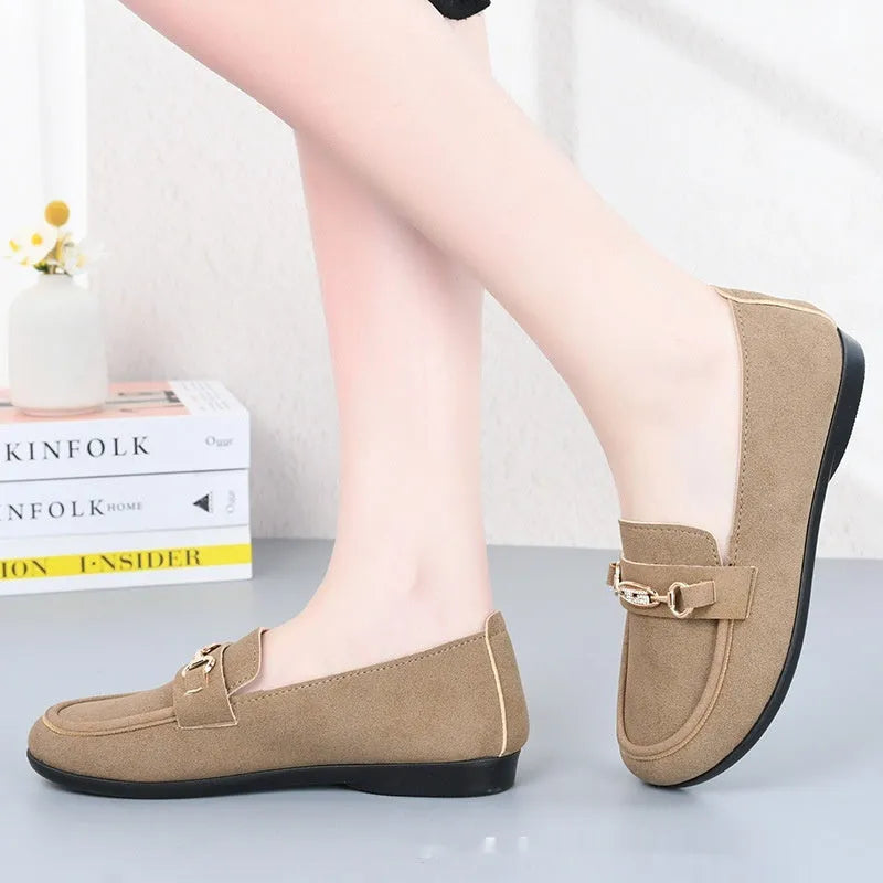 Gommino women's black slip-on casual shoes with a round toe and soft rubber sole on a white background.