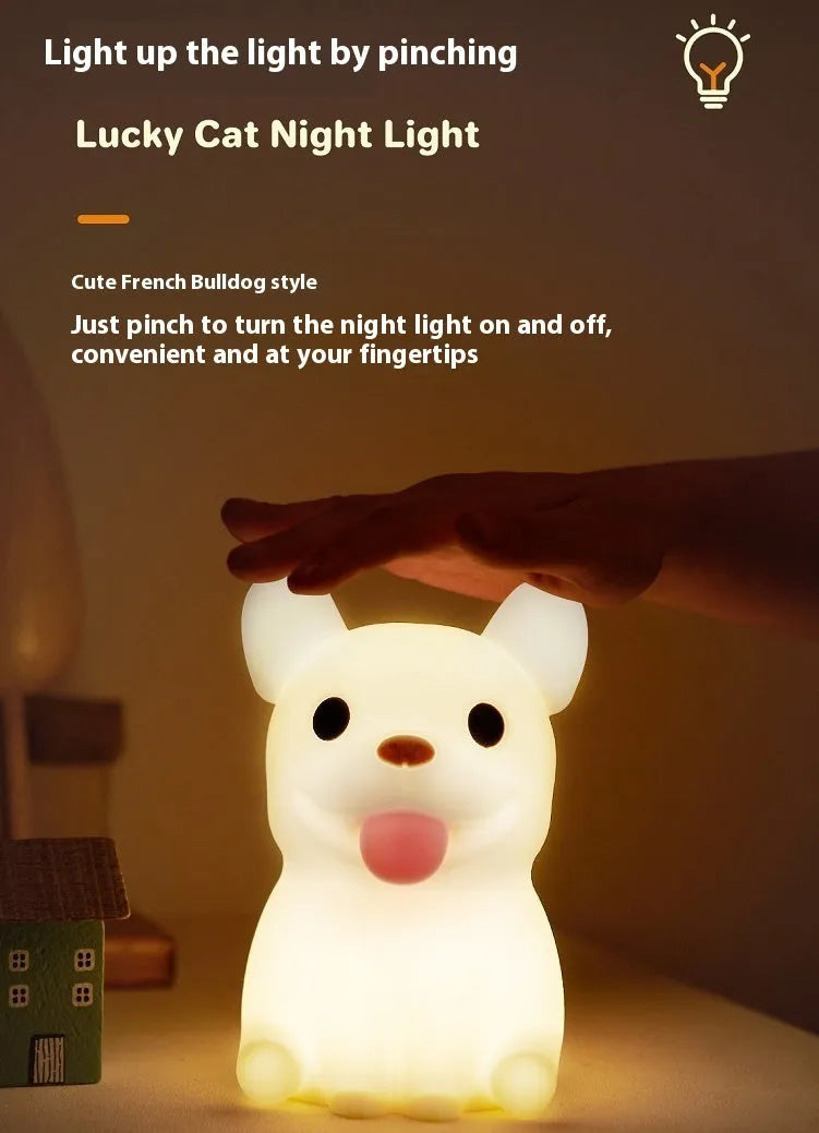 Cartoon animal silicone USB night light with dimmer switch on a bedside table.