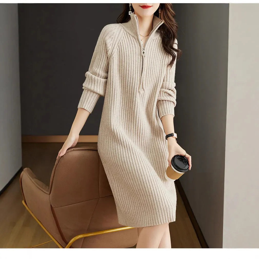 Beige half-zip woolen skirt with stand collar and long sleeves in a loose, straight dress cut.