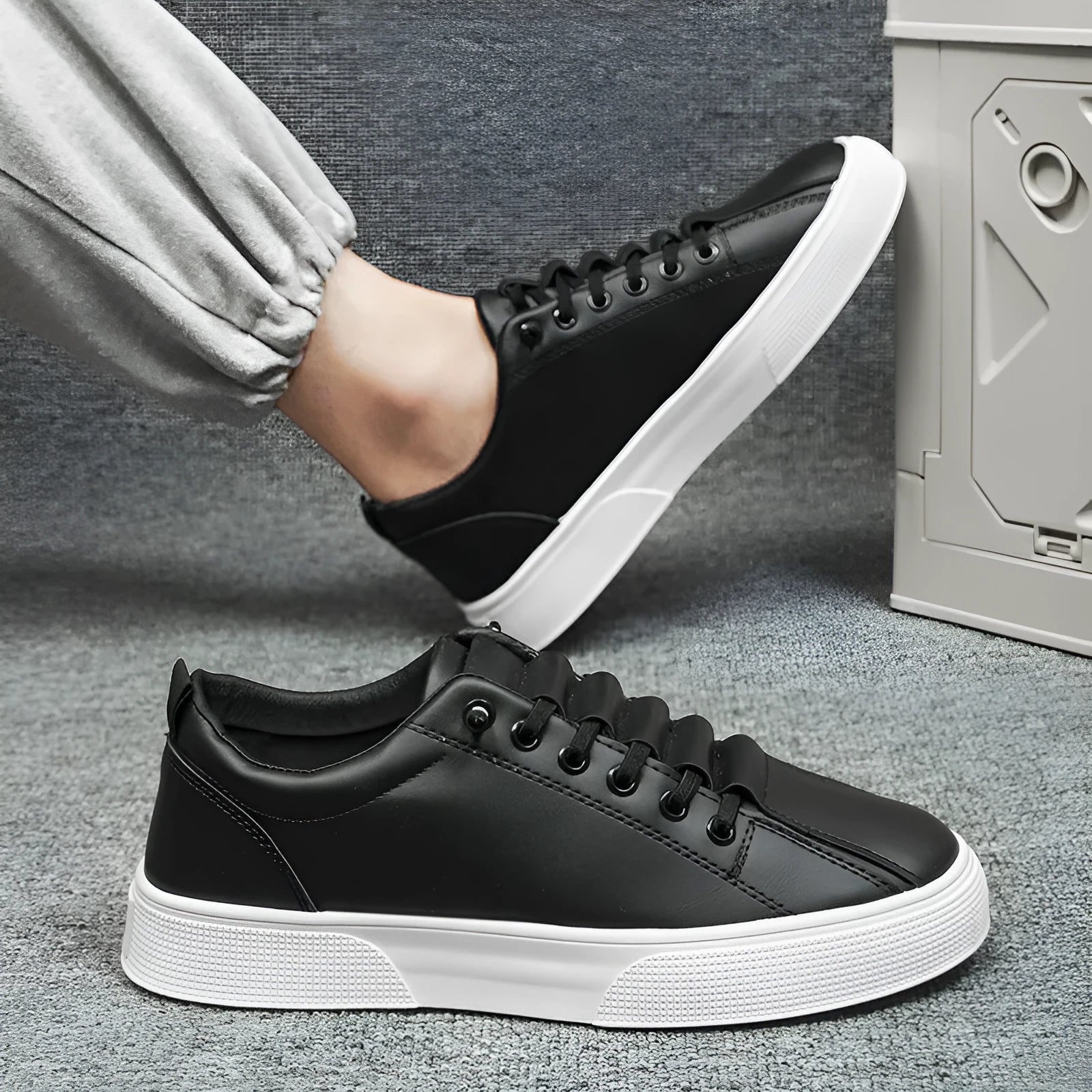 Men's black and white low top sports shoes with synthetic leather upper, mesh panels, and a flat PVC sole.