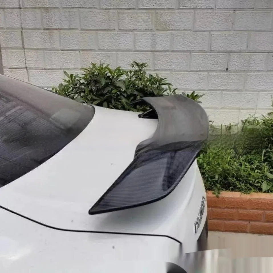 Universal car punch-free tail wing spoiler in ABS plastic, showing bright black, bright white, and carbon pattern finish options.