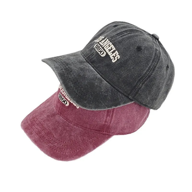 Adult personalised peaked cap with embroidered vintage letters, shown in beige colour.