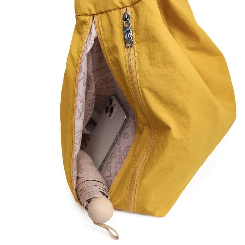 Women's heart-shaped nylon underarm bag in black, yellow, khaki, or blue colours showing large capacity design