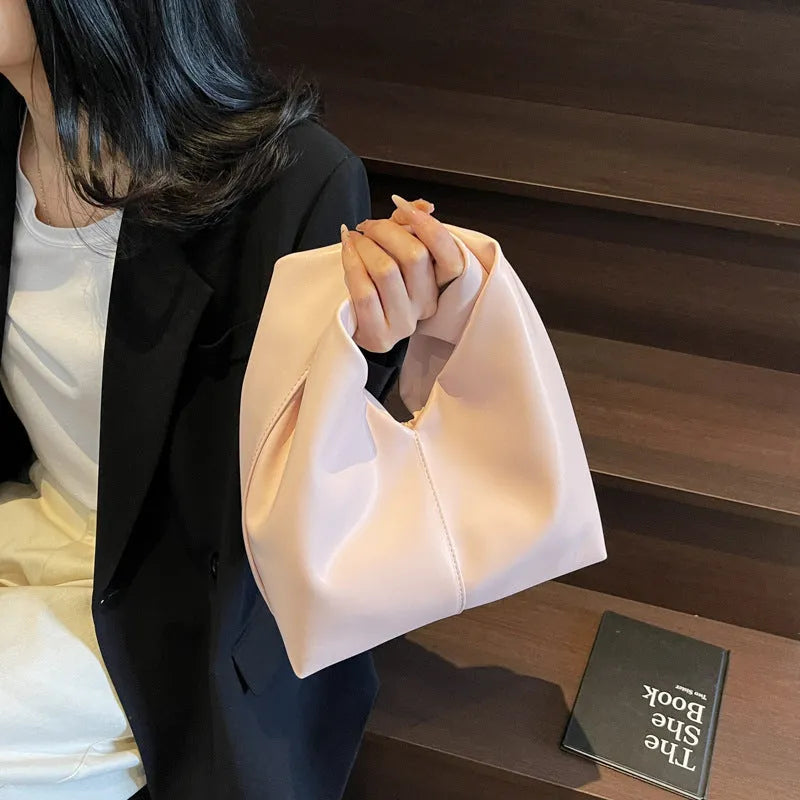 Women's casual dumpling-shaped PU leather handbag in multiple colours with internal organiser pockets.