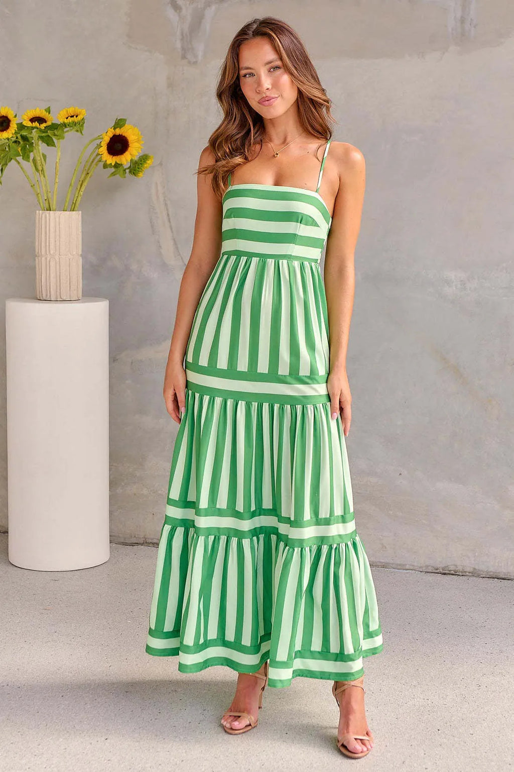 Women's striped suspender dress with square neckline, backless design, and side pockets