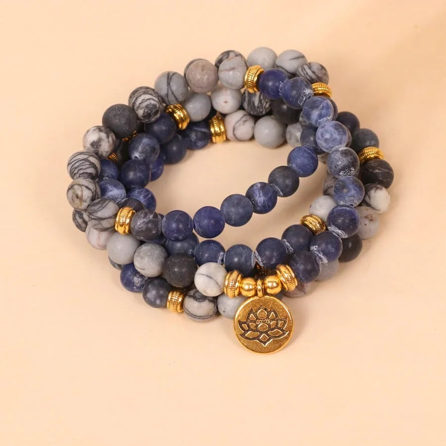 Blue multi layer bracelet with patterned network stone beads on alloy strands