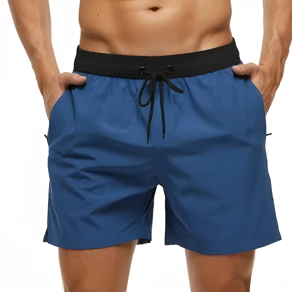 Men's blue running shorts with drawstring waist, stitching detail, and a headband pocket.