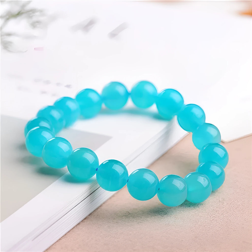 Natural blue-green Amazonite scattered bead bracelet on a wrist, showing polished stone beads in an original design.