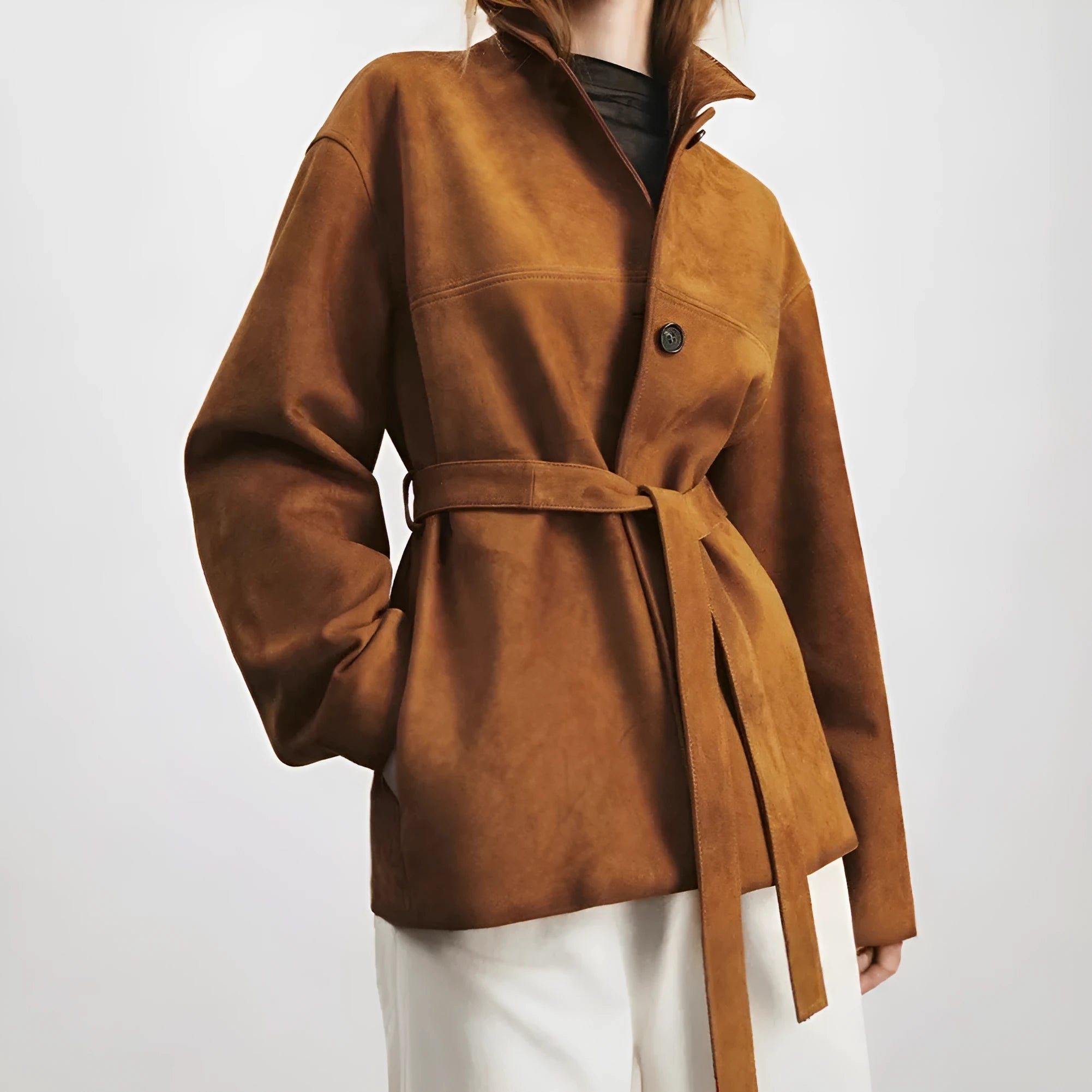 Women's caramel mocha cashmere coat with a peter pan collar and decorative leather stitching.