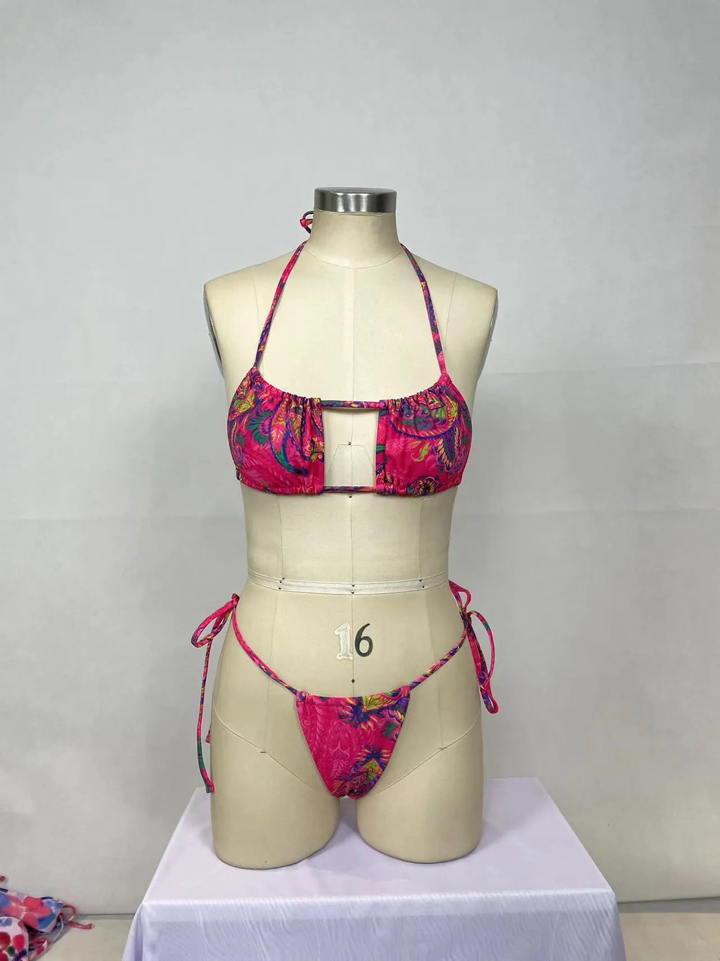 Women's pink nylon bikini two-piece set with sleeveless backless top and briefs bottom