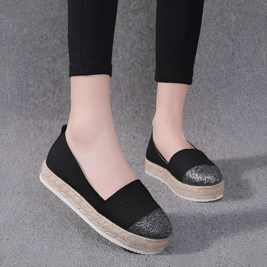 Plus size beige and black breathable canvas flat shoes with round toe and slip-on design.