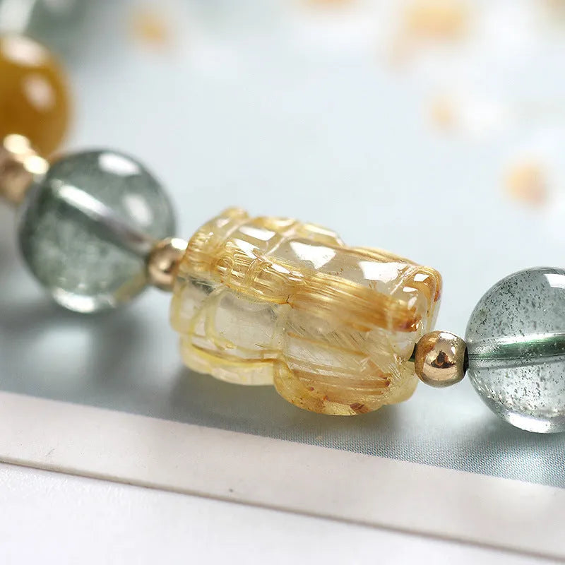 Green phantom quartz crystal bracelet with 8mm geometric beads showing gold rutile inclusions