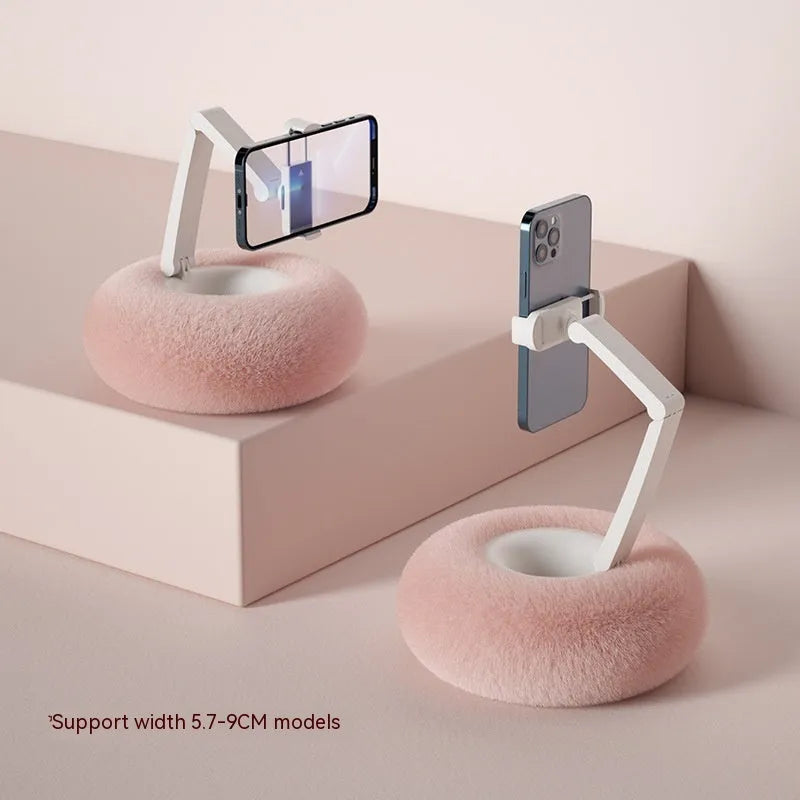 Adjustable rotating bracket holding a tablet on a desk, showing vertical lift and clamp mechanism.