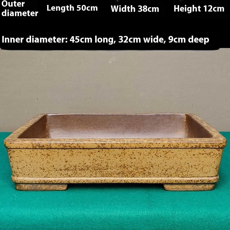Straight shallow rectangular Yixing purple sand flowerpot for plants on a surface.