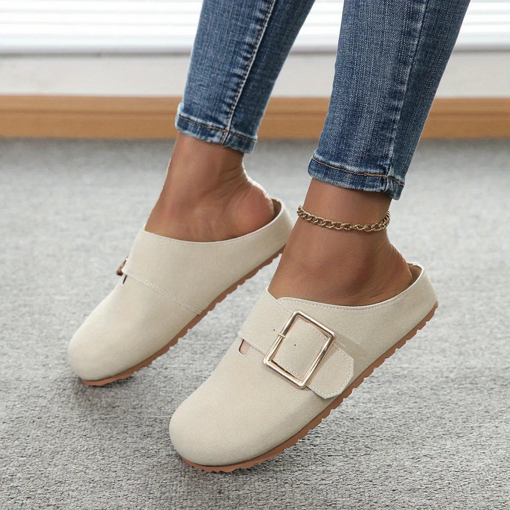 Women's brown closed toe low top canvas slippers shown from the side.
