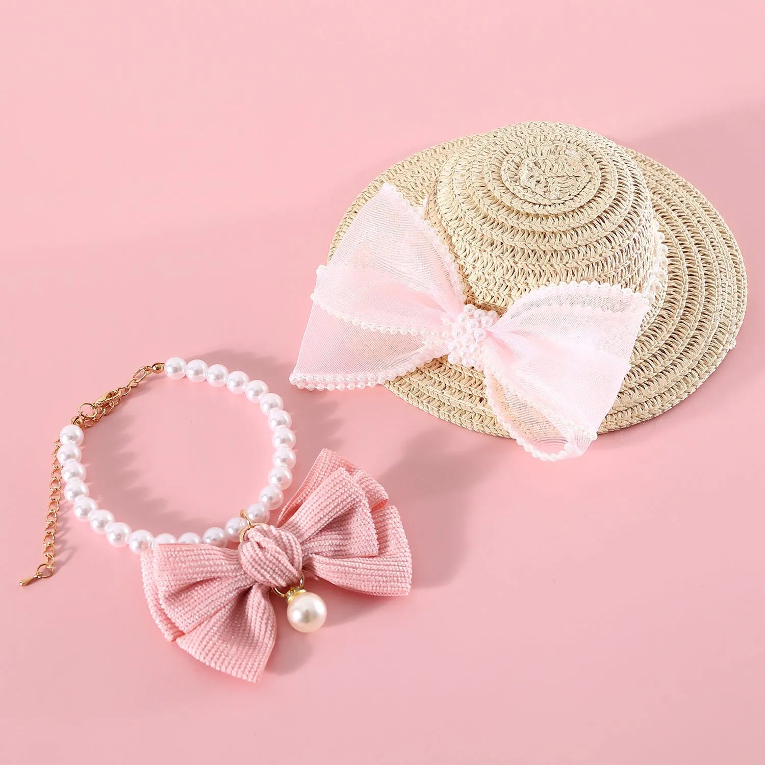 Pink pearl bow woven straw hat for a cat, shown in a princess style on a blank background.