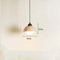 Yellow cave stone wabi sabi style marble bedside pendant light on a wooden surface