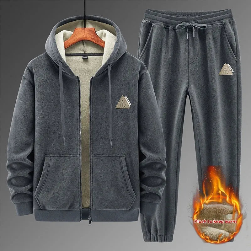 A grey men's casual sports suit featuring a hooded sweater and matching trousers on a hanger.