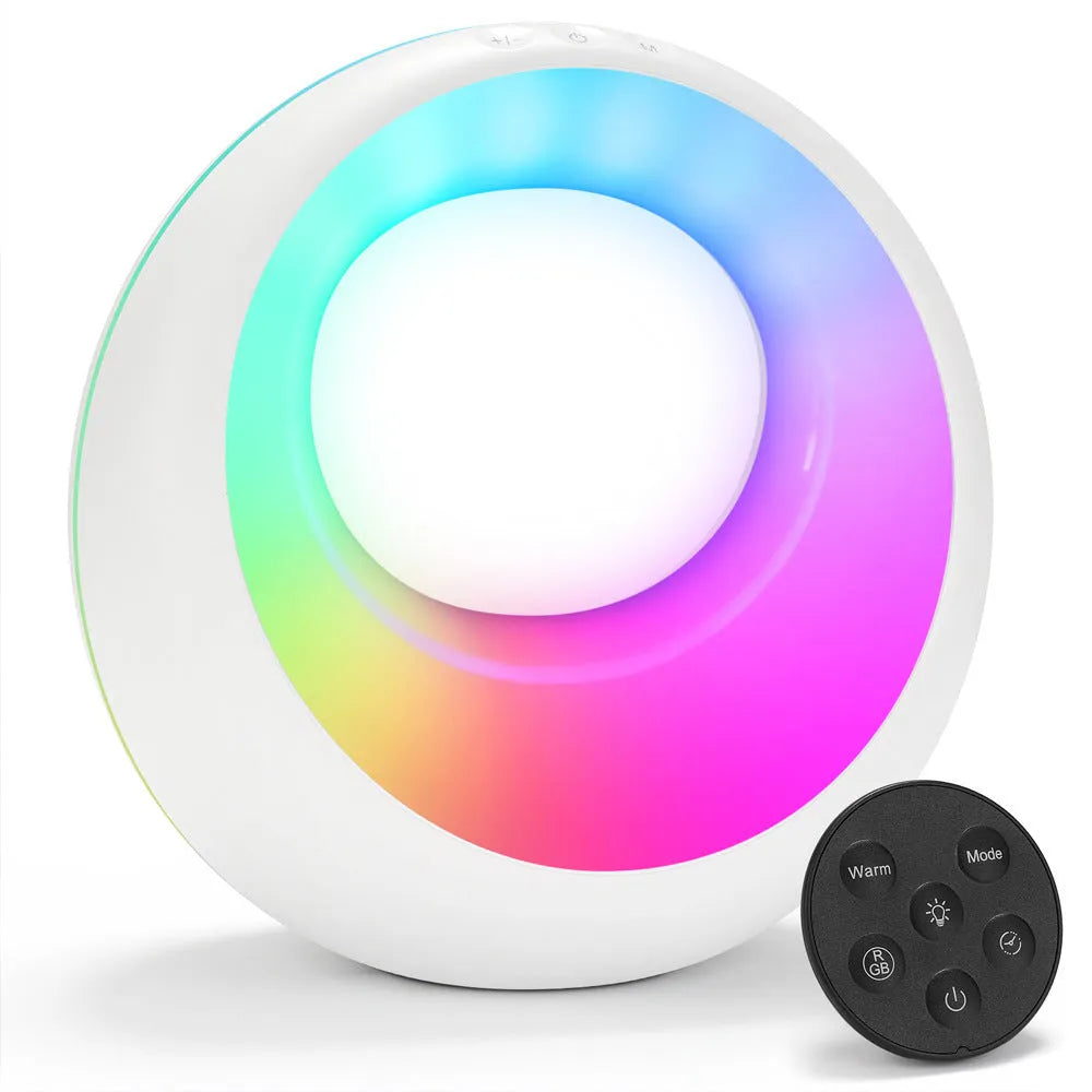 Small white RGB colour changing night lamp with remote control on a wooden desk.