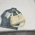 Large canvas shoulder tote bag in solid colour with sandwich pocket organisation